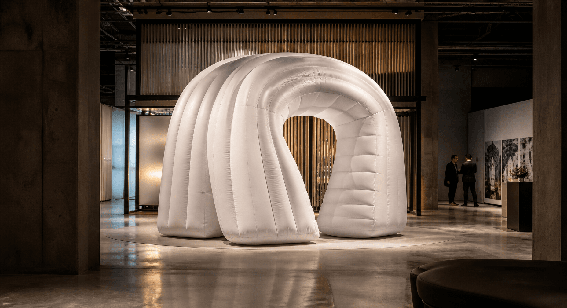 Large-scale inflatable installation being prepared inside a contemporary event venue.