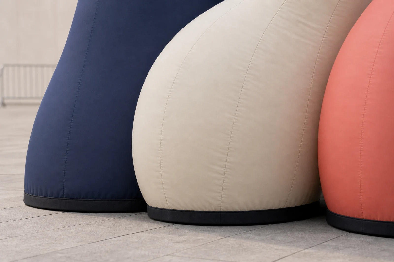 Close view of navy, cream, and coral inflatable surfaces, seams, and grounded bases.