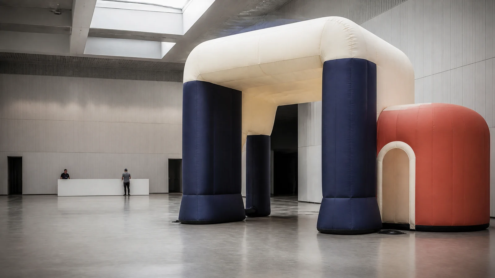 Large inflatable entrance installation inside a professional event venue.