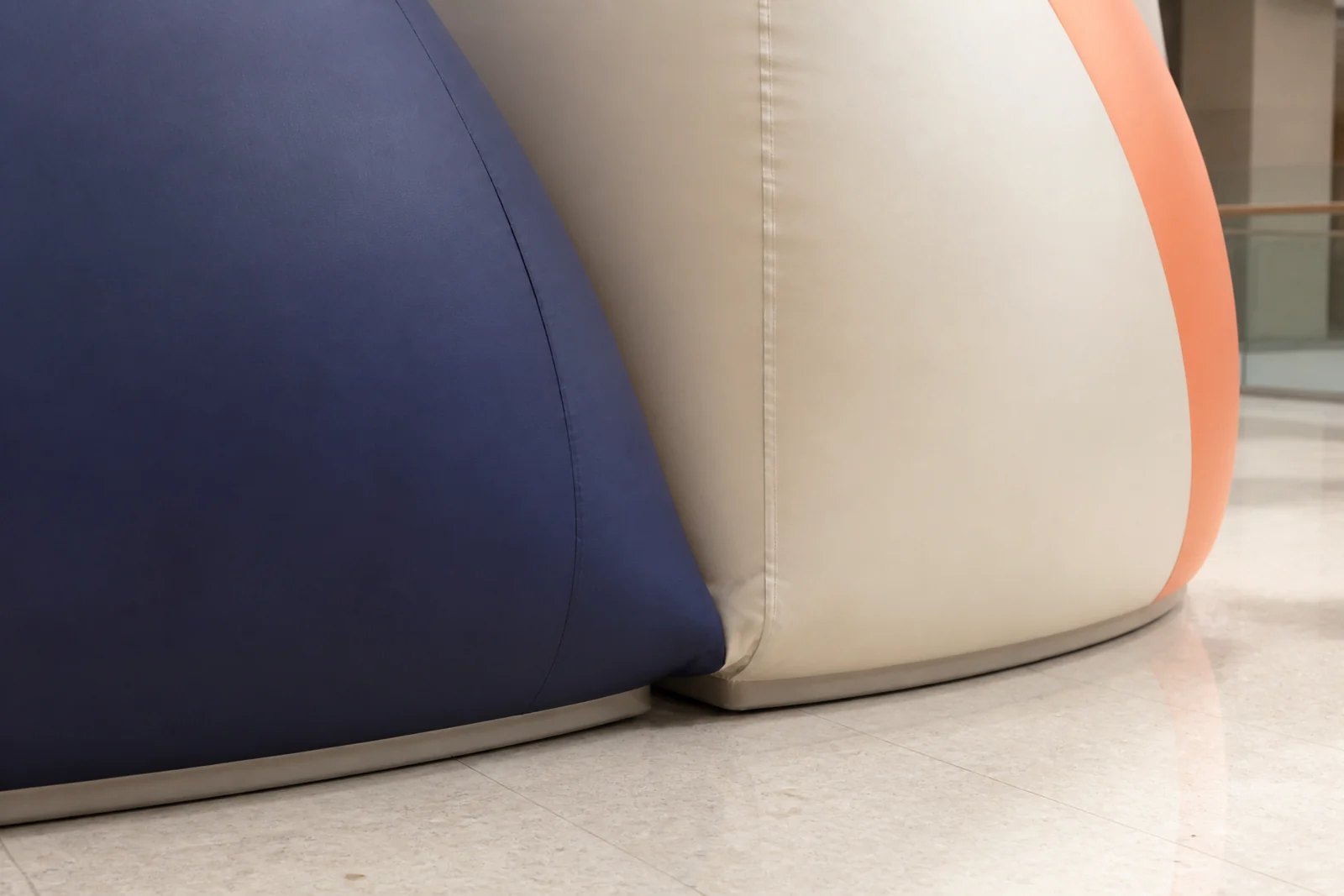 Close view of cream, navy, and coral inflatable retail surfaces and seams.