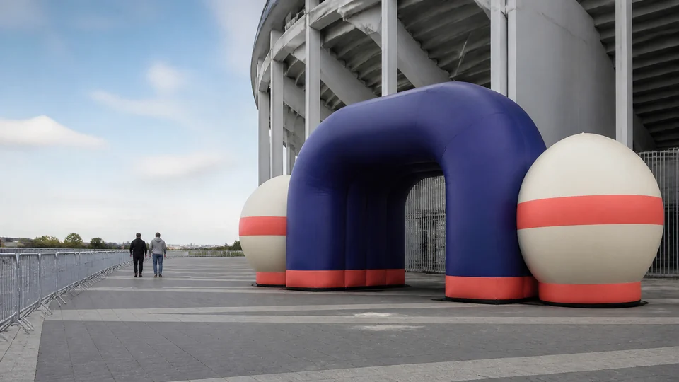 Inflatable fan-engagement entrance outside a generic stadium.